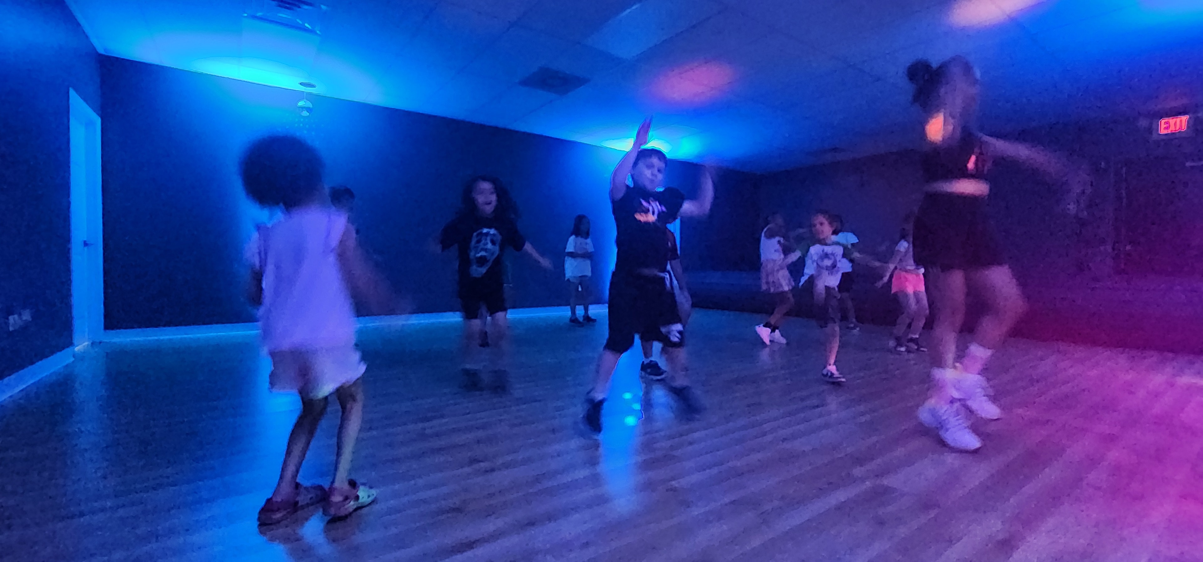 Campers dancing under colorful lights